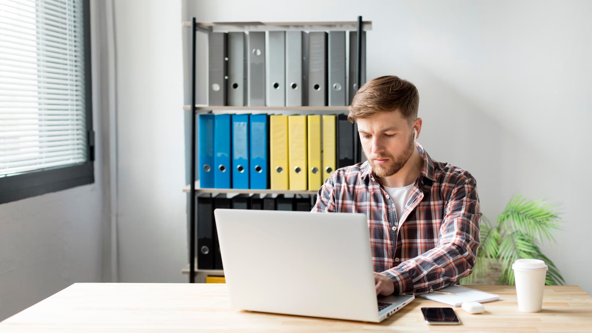A person typing a document on a laptop.
