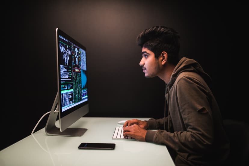 Close-up of a person coding on a laptop screen.